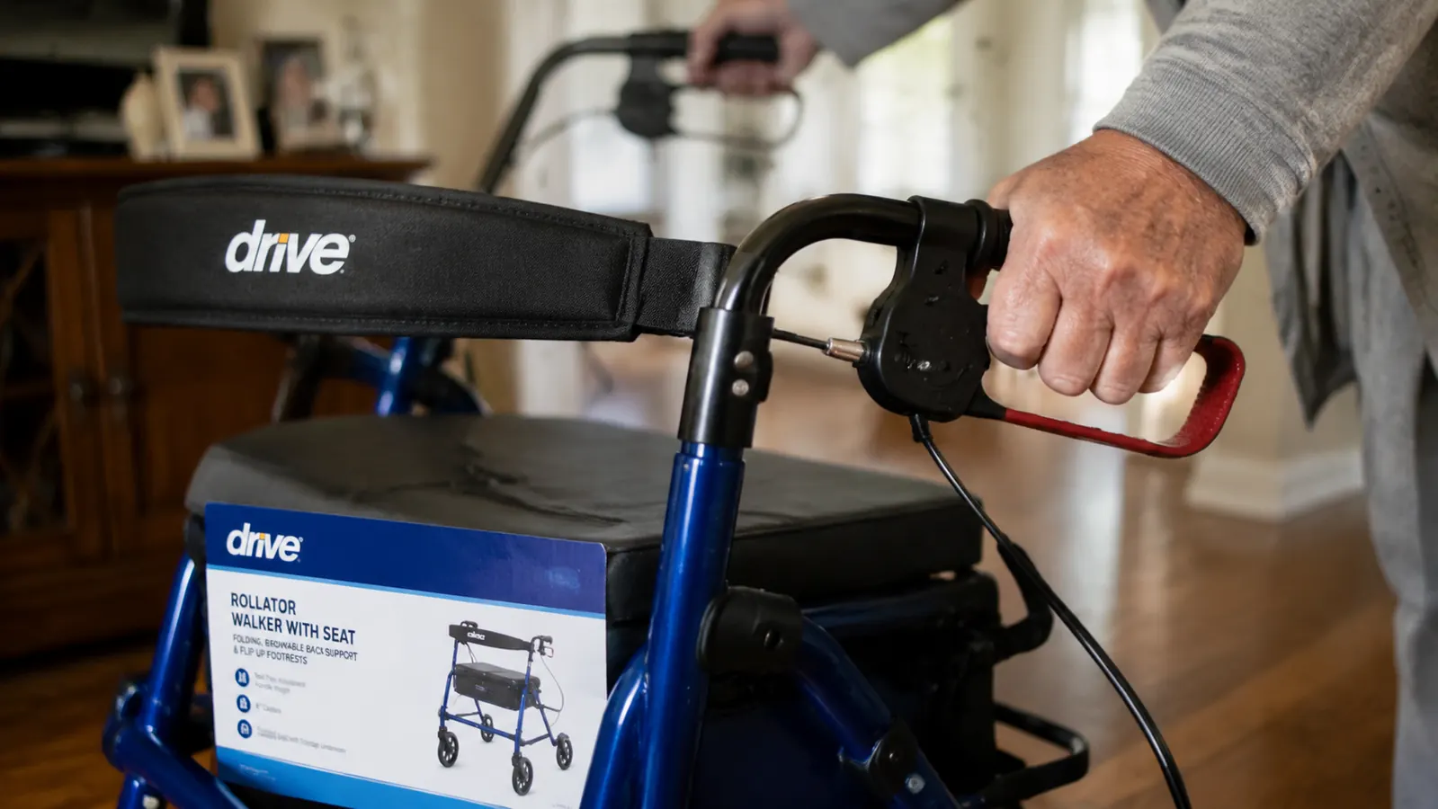 Caregiver squeezing the brake lever on a rollator walker to test cable tension before handing it to an elderly person
